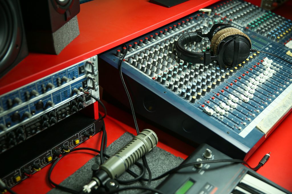 Sound recording equipment and headphones on a table in a music recording studio